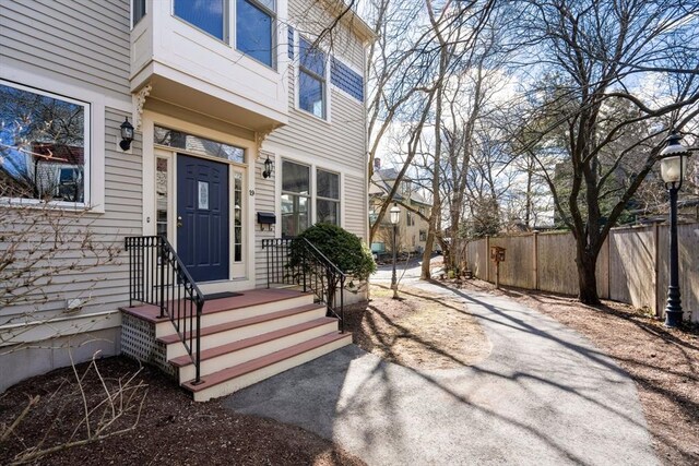 doorway to property featuring fence