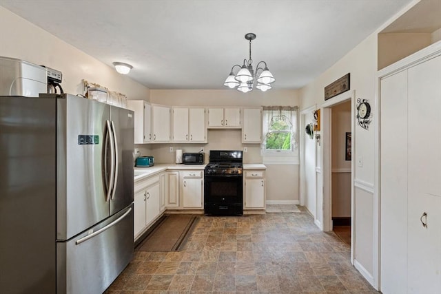 kitchen featuring black appliances, stone finish floors, light countertops, a chandelier, and baseboards