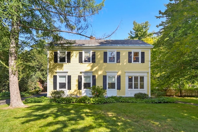 colonial home with a front lawn