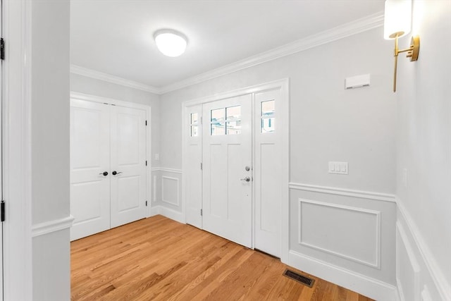 entrance foyer featuring hardwood / wood-style floors and ornamental molding