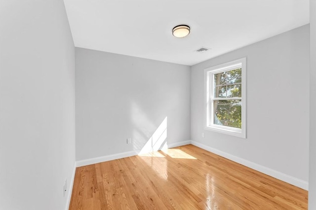 spare room with hardwood / wood-style floors