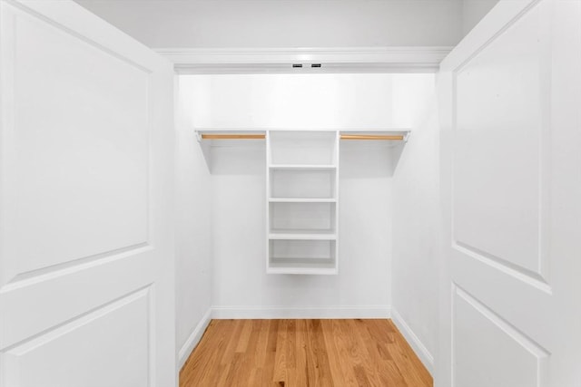 walk in closet with wood-type flooring