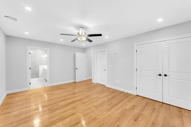 unfurnished bedroom featuring connected bathroom, ceiling fan, and light hardwood / wood-style flooring