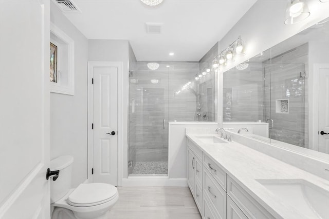 bathroom with toilet, vanity, and walk in shower