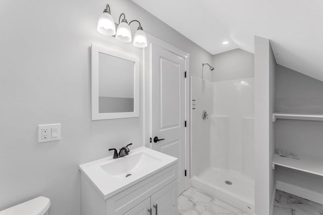 bathroom featuring a shower, vanity, toilet, and lofted ceiling