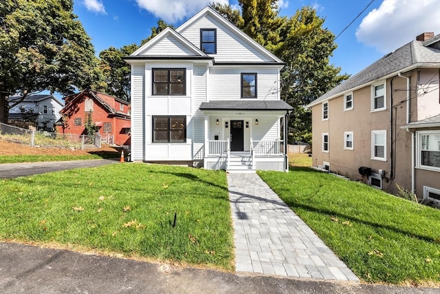 view of front property with covered porch and a front yard