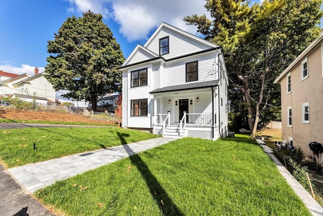 view of front of property featuring a porch and a front yard