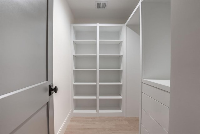 walk in closet featuring light wood finished floors and visible vents