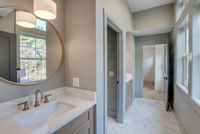 bathroom with vanity and baseboards