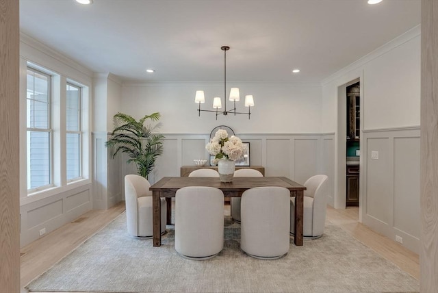 dining room with a chandelier, recessed lighting, plenty of natural light, and a decorative wall