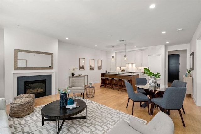 100 Linden St Unit 202, Wellesley, MA 02482 - living room with recessed lighting, light wood-style floors, and a glass covered fireplace