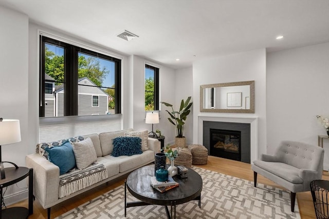 100 Linden St Unit 202, Wellesley, MA 02482 - living area with wood finished floors, a glass covered fireplace, and recessed lighting