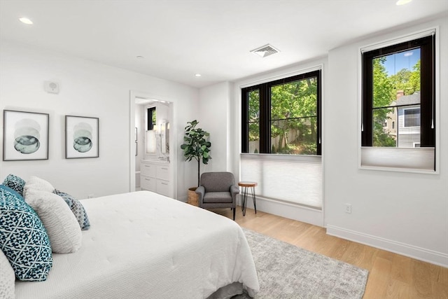 100 Linden St Unit 202, Wellesley, MA 02482 - bedroom with light wood-style flooring, recessed lighting, and ensuite bath