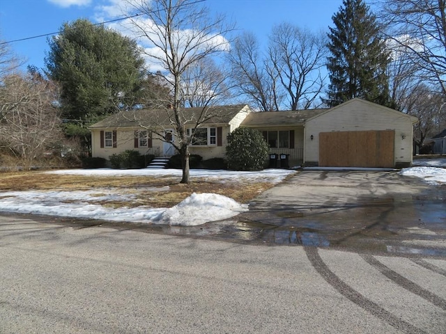 single story home with entry steps, a garage, and driveway