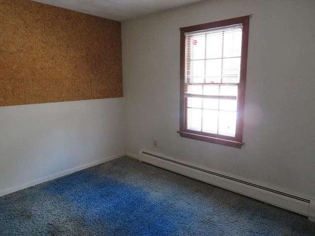 spare room featuring baseboard heating, plenty of natural light, and carpet floors