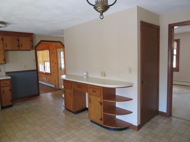 kitchen featuring wallpapered walls, light countertops, open shelves, and baseboard heating