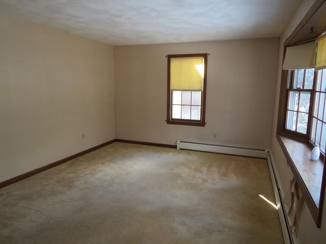 carpeted empty room with baseboard heating and baseboards