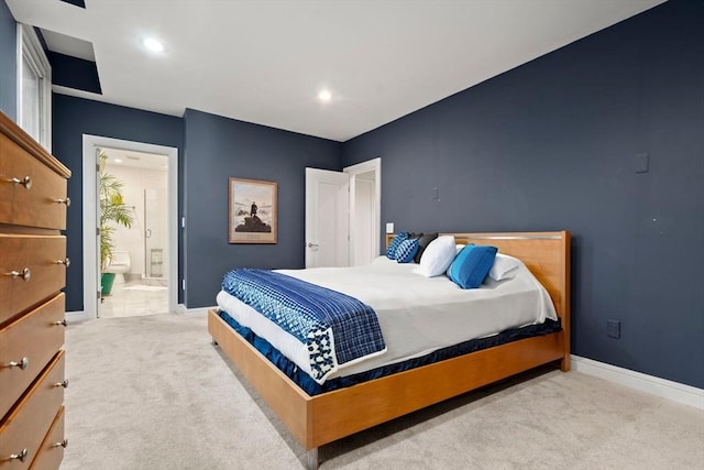 carpeted bedroom with recessed lighting, baseboards, and ensuite bathroom