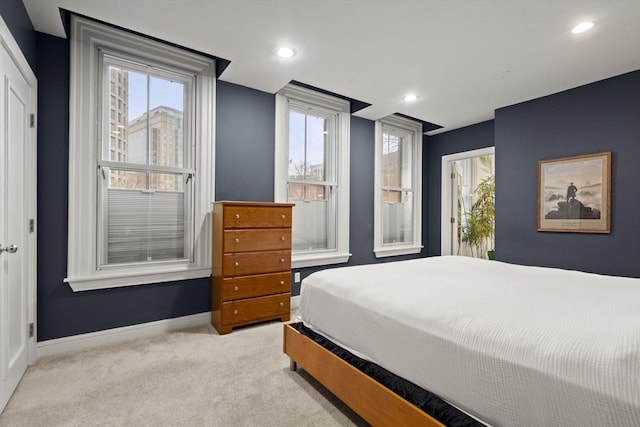 carpeted bedroom featuring recessed lighting and baseboards