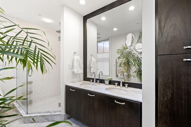 full bathroom with double vanity, a stall shower, a sink, and recessed lighting