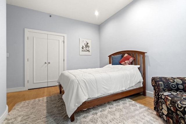 bedroom with baseboards and wood finished floors