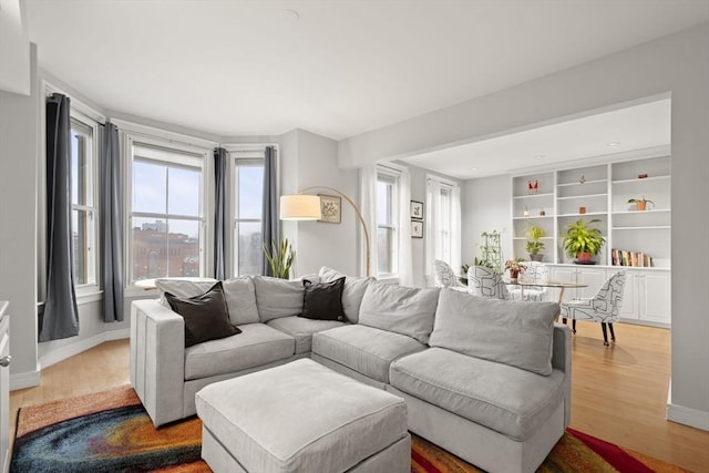 living area featuring baseboards and wood finished floors