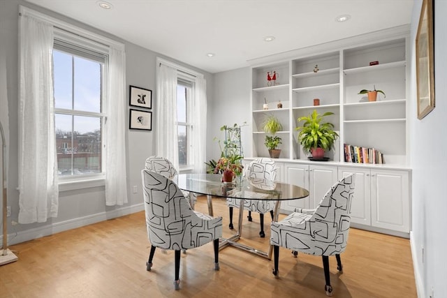 dining area with light wood-type flooring, baseboards, and recessed lighting