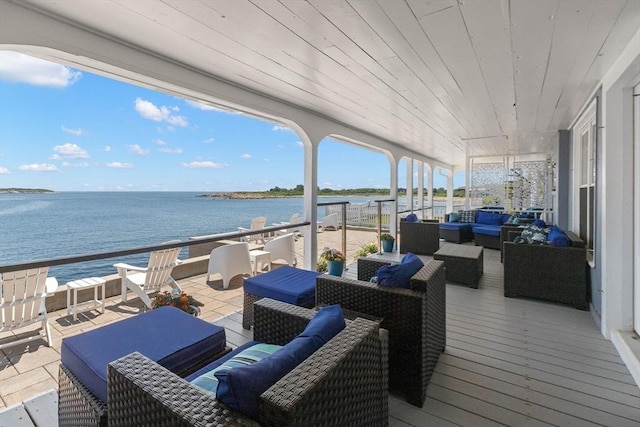 deck featuring outdoor lounge area and a water view