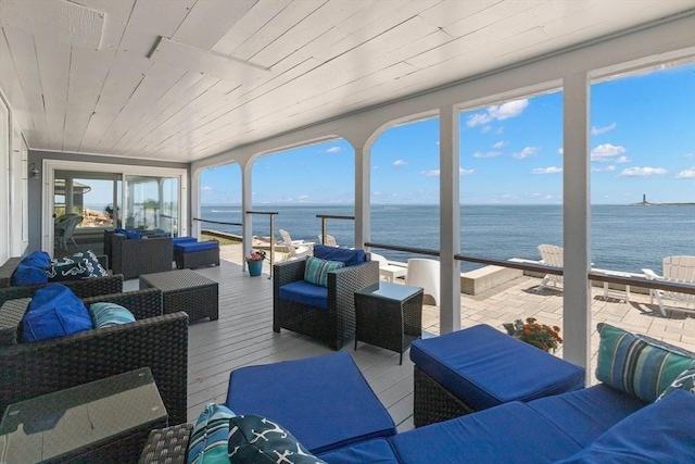 sunroom / solarium with a water view and wood ceiling