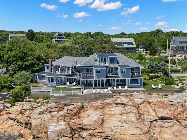 rear view of property with a balcony