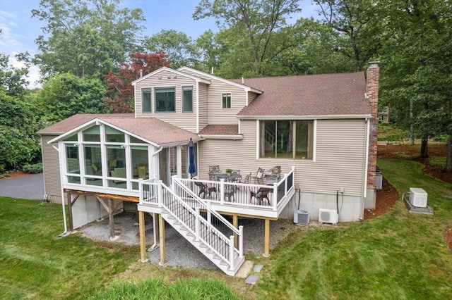 18 Juniper Ln, Framingham, MA 01701 - rear view of property with a shingled roof, a chimney, a sunroom, a yard, and a deck