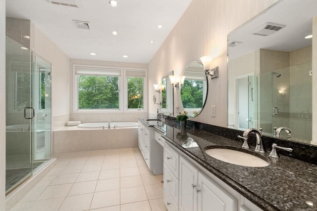 18 Juniper Ln, Framingham, MA 01701 - full bathroom with double vanity, a garden tub, a shower stall, tile patterned flooring, and recessed lighting