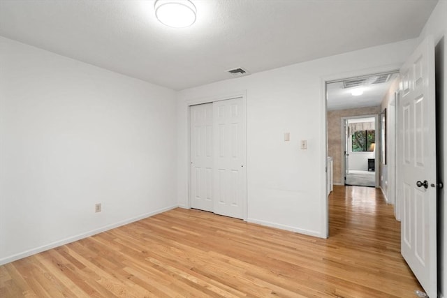 18 Juniper Ln, Framingham, MA 01701 - unfurnished bedroom featuring light wood finished floors and a closet