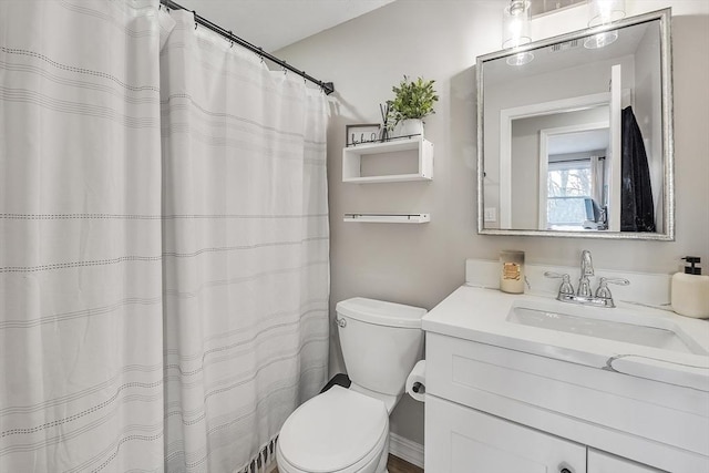 bathroom featuring vanity and toilet