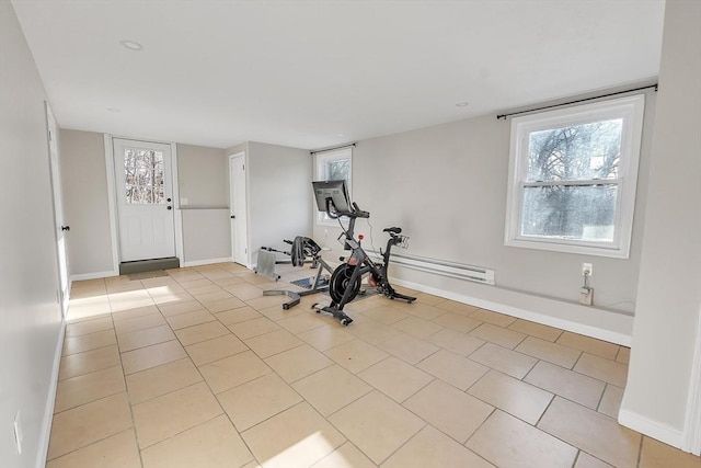 exercise area with light tile patterned floors and baseboard heating