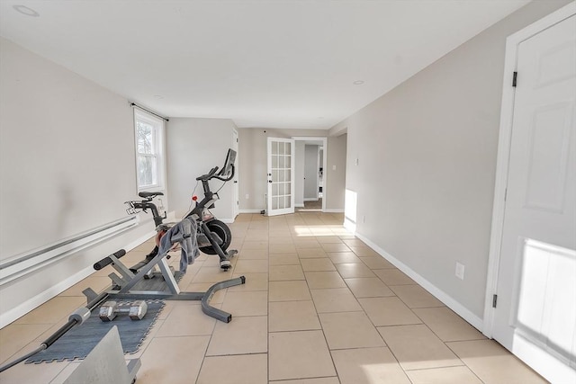 workout area with light tile patterned floors and french doors