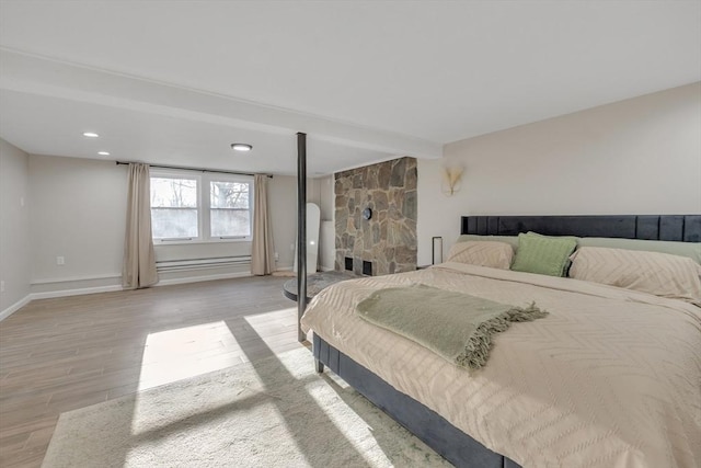 bedroom featuring beam ceiling and light wood-type flooring