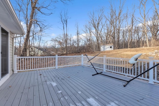 wooden terrace with a storage shed