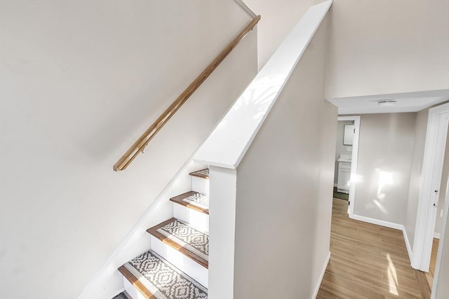 stairs with hardwood / wood-style floors