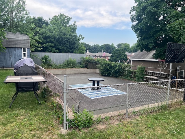 view of yard with a storage unit and a patio