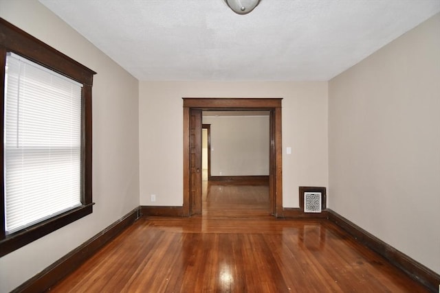 spare room with wood-type flooring