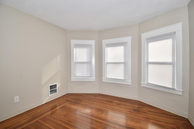 unfurnished room featuring hardwood / wood-style flooring