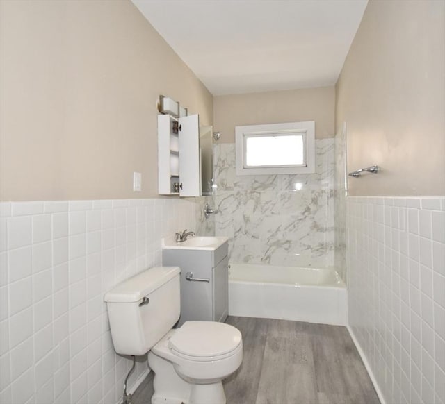 full bathroom with toilet, vanity, tile walls, and hardwood / wood-style flooring