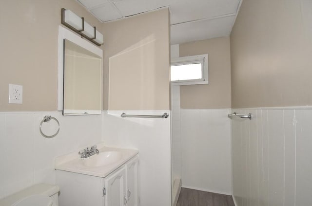 bathroom featuring vanity, hardwood / wood-style flooring, and toilet