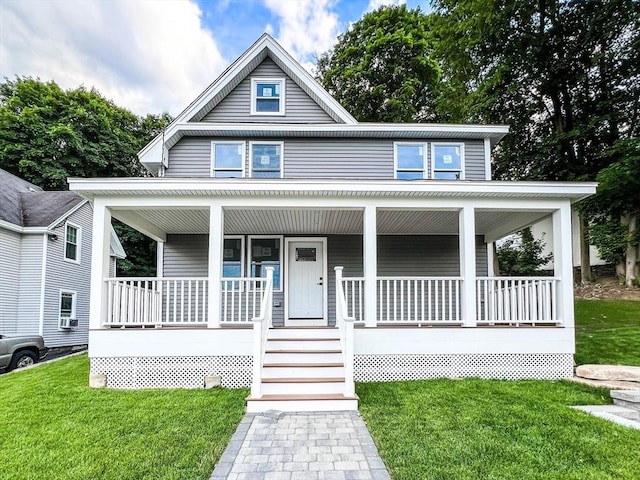 view of front facade with a front lawn and covered porch