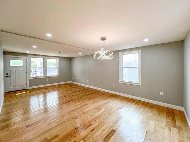 unfurnished room featuring recessed lighting, baseboards, and light wood finished floors