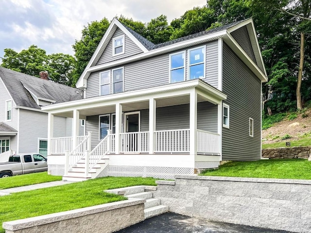 view of front of home featuring a front yard and covered porch