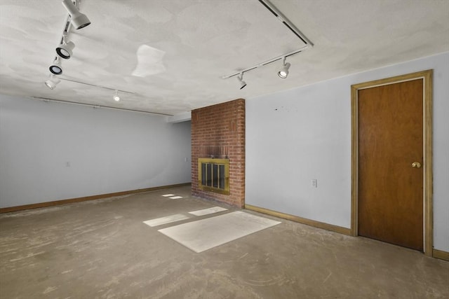 unfurnished living room with concrete flooring and a brick fireplace