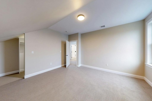 bonus room featuring light colored carpet and lofted ceiling