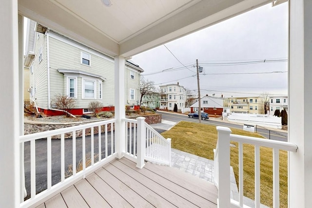 wooden deck with covered porch and a yard